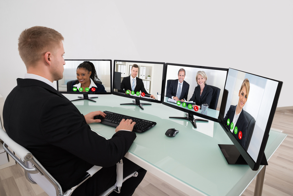 Businessman Video Conferencing On Desk