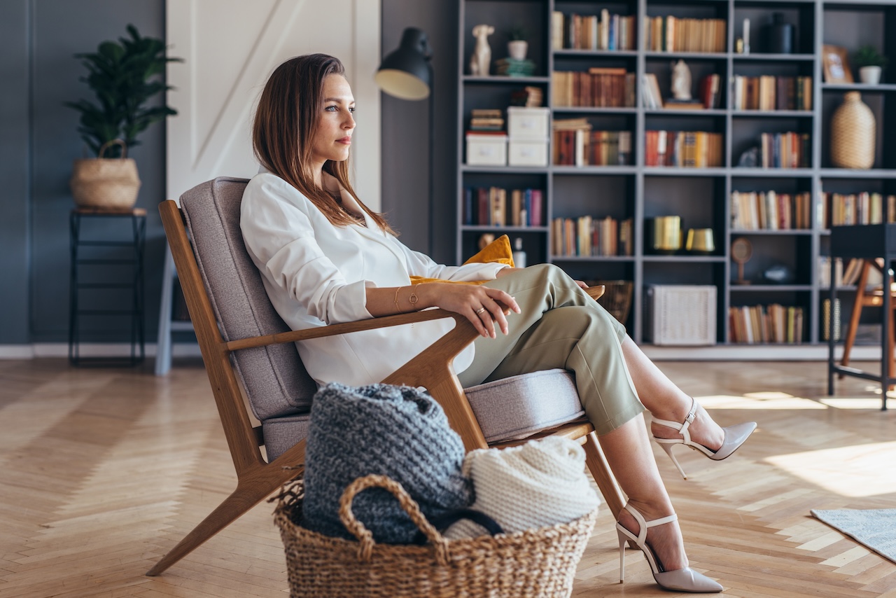 Business Woman Sitting In A Chair At Home.